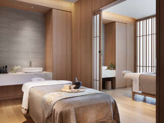Indulge in tranquility at our luxurious spa, featuring serene private treatment rooms with plush massage tables and modern amenities.