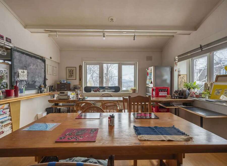 Cozy and eclectic lodge with a large communal table perfect for gatherings.