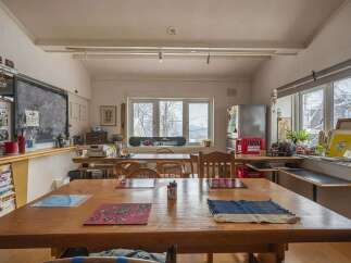 Cozy and eclectic lodge with a large communal table perfect for gatherings.