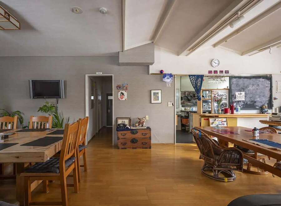 This charming hostel boasts a spacious communal area with multiple dining tables, perfect for socializing with fellow travelers.