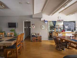 This charming hostel boasts a spacious communal area with multiple dining tables, perfect for socializing with fellow travelers.
