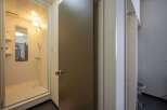 This cozy apartment features a compact yet functional shower stall, perfect for quick and easy morning routines.