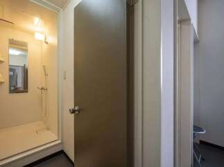 This cozy apartment features a compact yet functional shower stall, perfect for quick and easy morning routines.