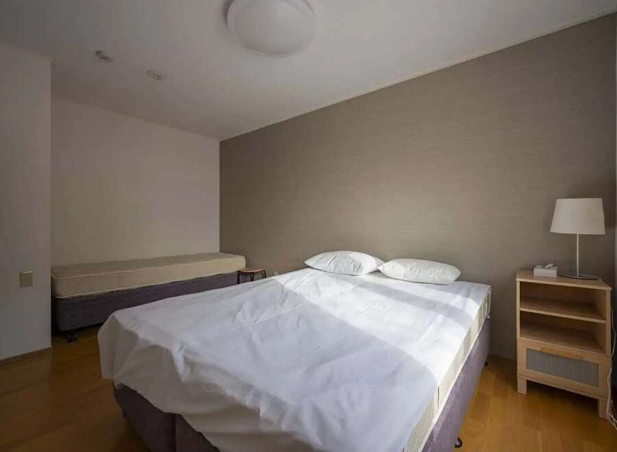 Bright and airy bedroom with two beds, perfect for guests or roommates.