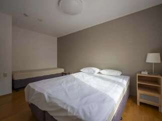 Bright and airy bedroom with two beds, perfect for guests or roommates.