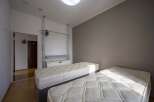 Cozy twin bedroom with built-in closet and neutral wall tones.