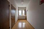 This hallway boasts light wood flooring and neutral walls, creating a bright and airy atmosphere.