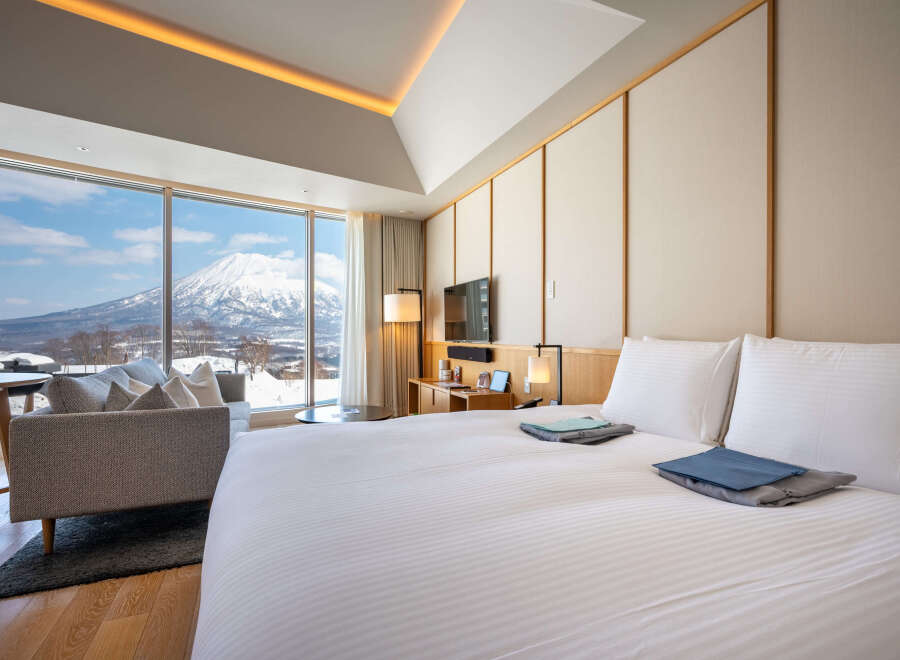 Wake up to breathtaking mountain views from this luxurious hotel room.