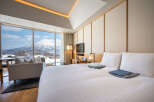 Wake up to breathtaking mountain views from this luxurious hotel room.