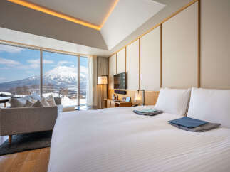 Wake up to breathtaking mountain views from this luxurious hotel room.