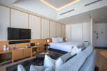 This modern hotel room boasts a comfortable king-size bed, a sleek flat-screen TV, and a cozy seating area perfect for relaxing.