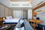 This modern studio apartment boasts a comfortable queen-size bed, a well-equipped kitchenette, and a stylish living area with a cozy sofa.
