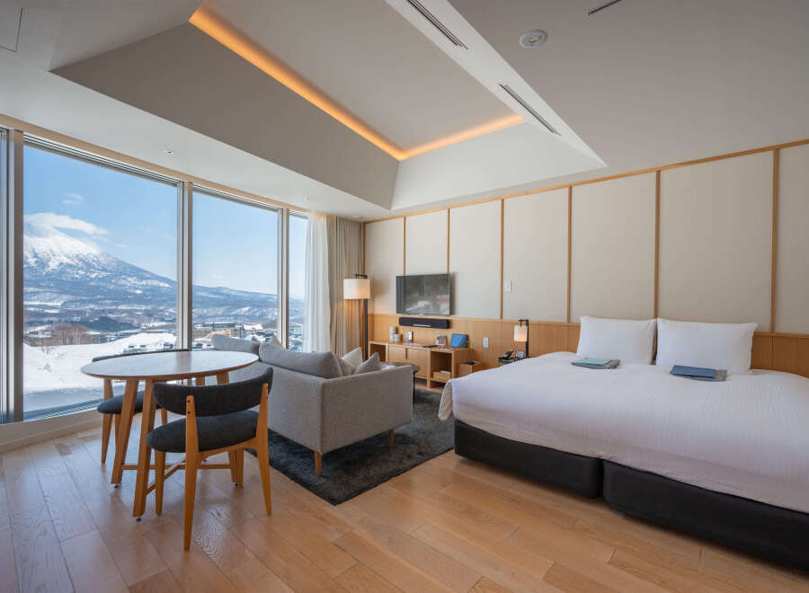 Wake up to breathtaking mountain views from this luxurious hotel room.