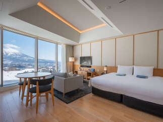 Wake up to breathtaking mountain views from this luxurious hotel room.