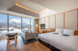Wake up to breathtaking views of snow-capped mountains from this luxurious hotel room.