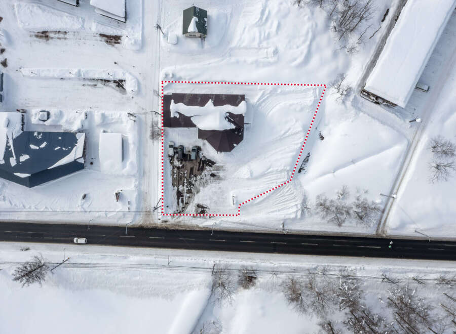This snow-covered commercial property is located near a main road, providing excellent visibility and accessibility.