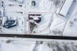 This snow-covered commercial property is located near a main road, providing excellent visibility and accessibility.