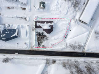 This snow-covered commercial property is located near a main road, providing excellent visibility and accessibility.