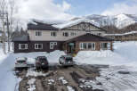 Nestled in a snowy mountain setting, this charming lodge offers comfortable accommodations and stunning views.