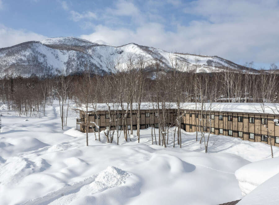 Nestled in a snowy mountain landscape, this charming lodge offers breathtaking views and cozy accommodations.