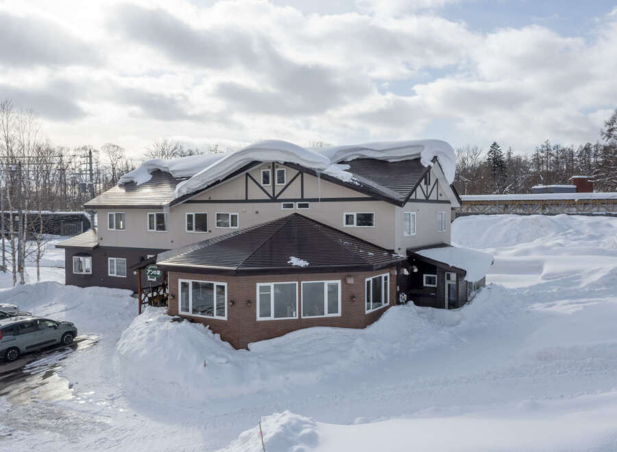 This charming snow-covered lodge offers the perfect winter getaway.