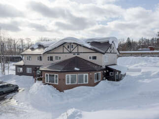 This charming snow-covered lodge offers the perfect winter getaway.