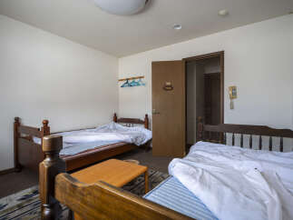 Cozy twin room with two wooden beds, offering a simple and comfortable stay.