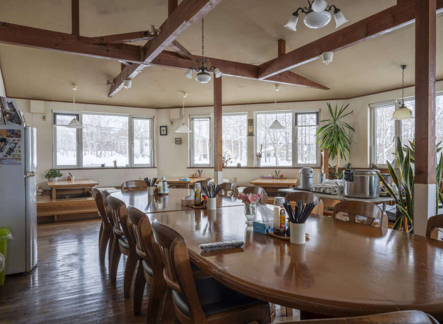 This cozy restaurant boasts a rustic charm with exposed wooden beams and large windows offering scenic views.