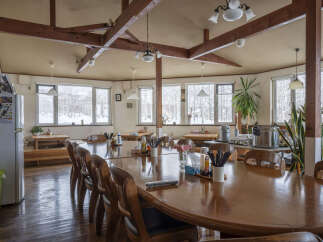 This cozy restaurant boasts a rustic charm with exposed wooden beams and large windows offering scenic views.