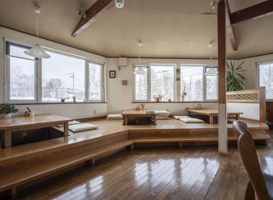 Cozy Japanese-style restaurant with tatami seating and wooden floors.
