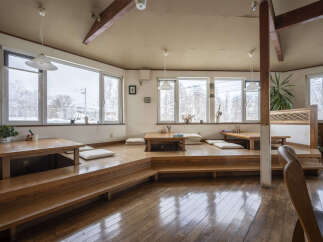 Cozy Japanese-style restaurant with tatami seating and wooden floors.