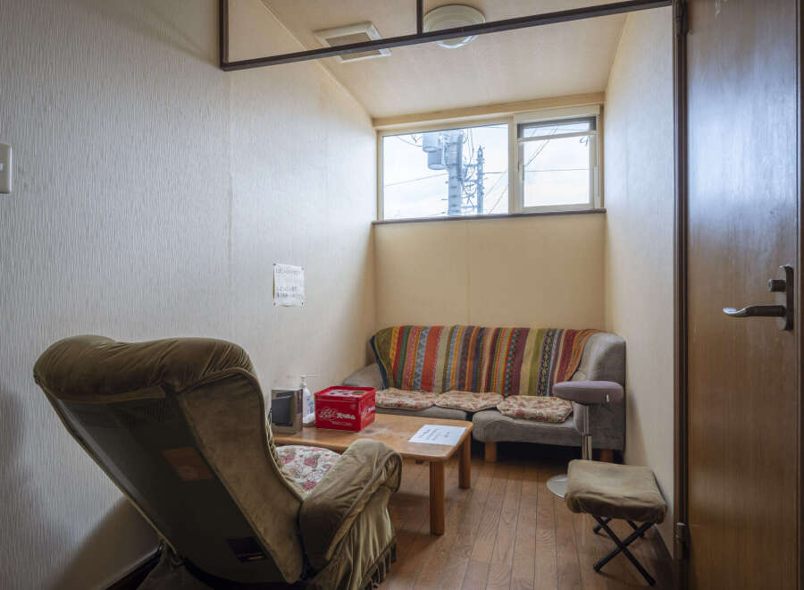 Cozy waiting area with comfortable seating and a small table.