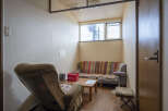 Cozy waiting area with comfortable seating and a small table.