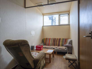 Cozy waiting area with comfortable seating and a small table.