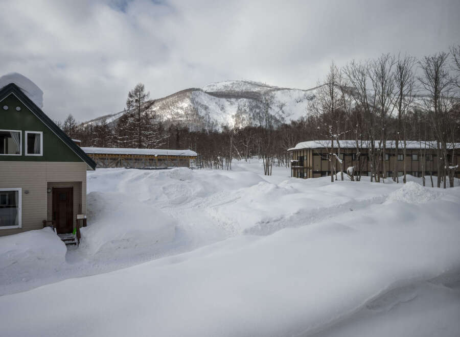Cozy cabin nestled in a snowy mountainside, perfect for a winter getaway.