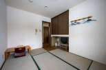 This cozy room features tatami mats, a built-in closet, and a small desk.