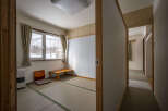 Cozy Japanese-style room with tatami mats, offering a serene atmosphere and mountain views.