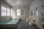 Relax and rejuvenate in this serene onsen, featuring a spacious bathtub perfect for soaking in the soothing waters.