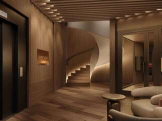 Experience luxurious living in this stunning building, featuring a sleek elevator, a modern curved staircase, and a sophisticated lobby.