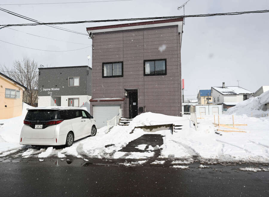 Cozy 2-story house nestled in a snowy neighborhood.