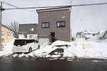 Cozy 2-story house nestled in a snowy neighborhood.