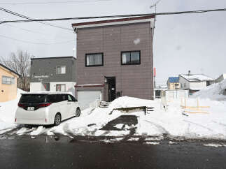 Cozy 2-story house nestled in a snowy neighborhood.