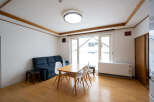 Bright and airy living space with hardwood floors and large windows offering ample natural light.