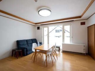 Bright and airy living space with hardwood floors and large windows offering ample natural light.