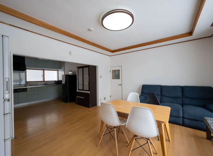 This cozy apartment boasts a modern kitchen with sleek gray cabinets and stainless steel appliances.