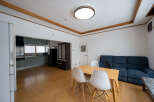This cozy apartment boasts a modern kitchen with sleek gray cabinets and stainless steel appliances.