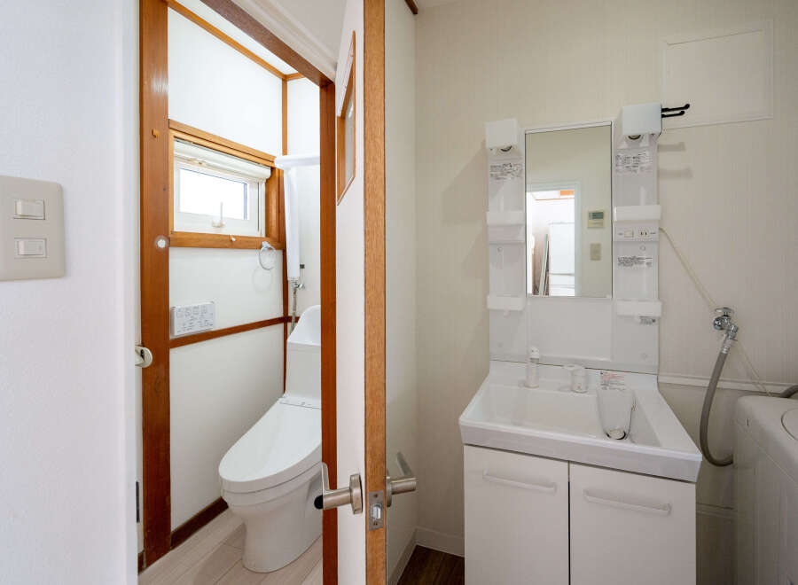 This cozy bathroom boasts a modern toilet and sink, perfect for everyday use.