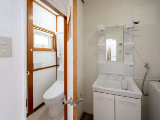 This cozy bathroom boasts a modern toilet and sink, perfect for everyday use.