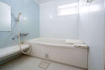 This charming bathroom boasts a clean and modern aesthetic, featuring a bathtub with a convenient built-in seat.