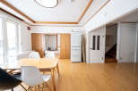 Bright and airy living space with hardwood floors and large windows.